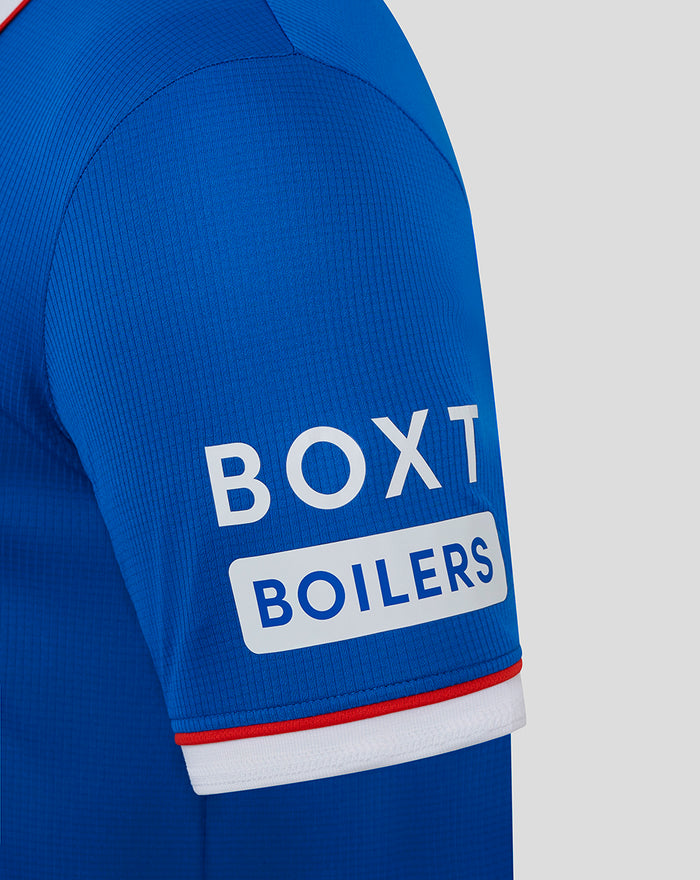 Rangers blue home shirt sleeve close-up showing Box Boilers sponsor on the sleeve and white cuff with red trim