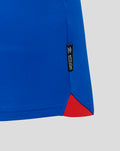 Close-up of blue Rangers FC 25/26 home shirt hem showing a red side insert and an official licensed product tag.