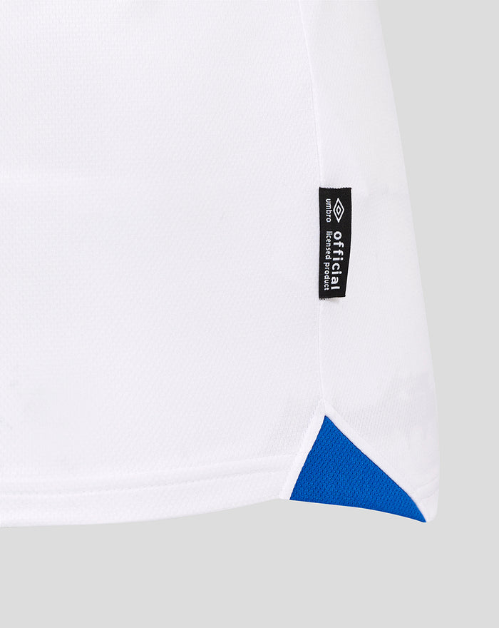 Side view of white Rangers away shirt showing a black official product tag and a blue triangle hem detail