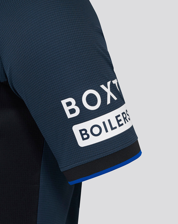 Close up of sleeve on navy Rangers away Pro shirt with blue trim at the cuff and BOX Boilers sponsor text.