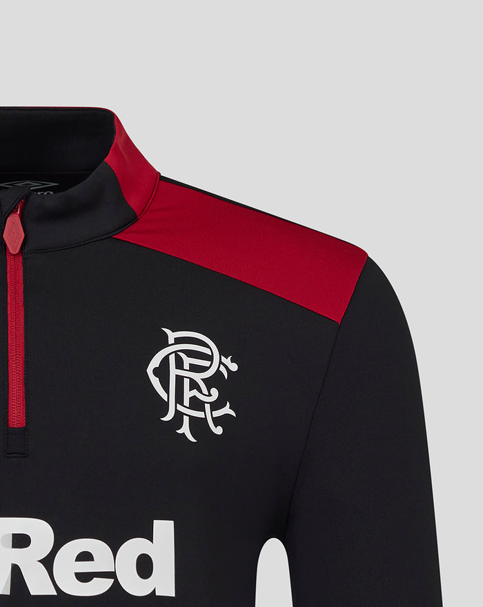 Close-up of men's black coaches training quarter zip top with red shoulder panel and white crest on chest.
