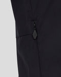 Close-up of black men's packable hood shower jacket showing a zip pocket and diamond pull.