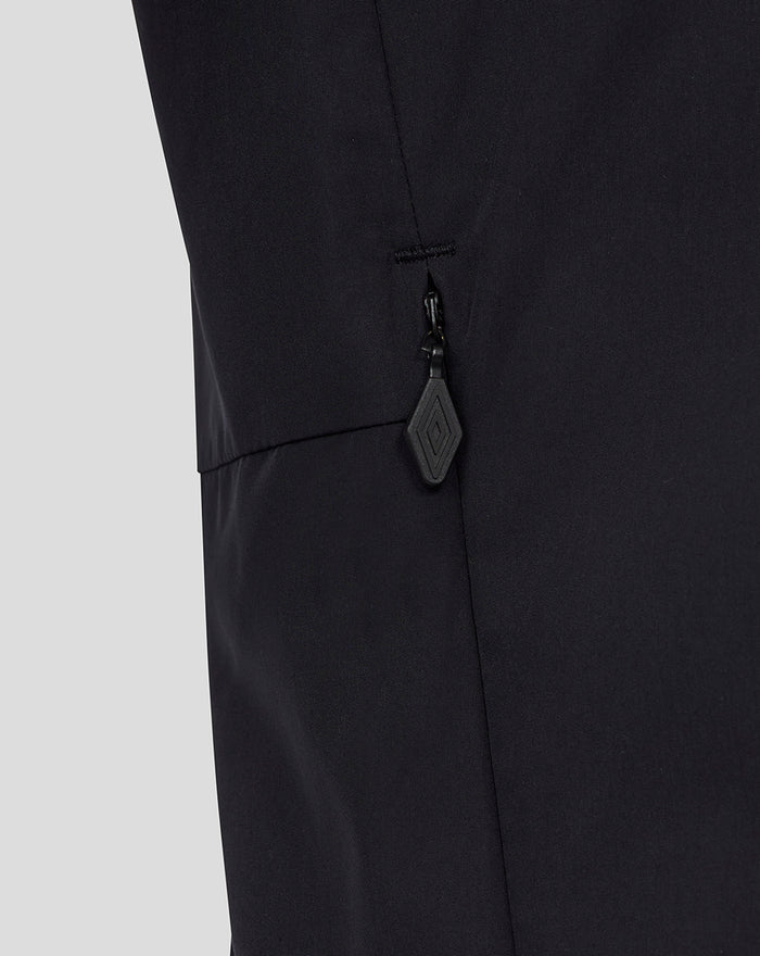 Close-up of black men's packable hood shower jacket showing a zip pocket and diamond pull.