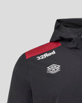 Shoulder close-up of men's black jacket with red stripe and 32Red logo and training emblem