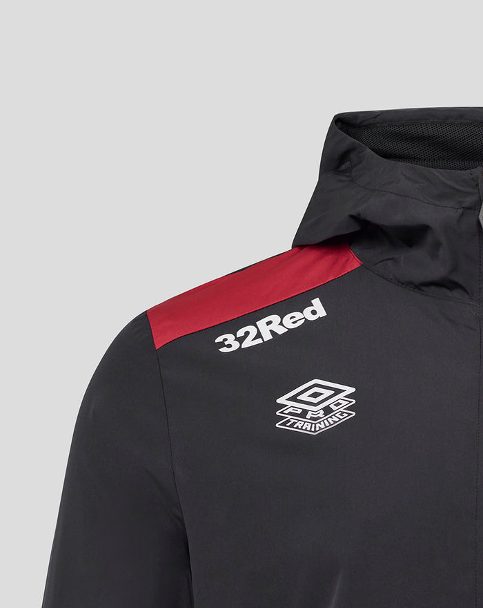 Shoulder close-up of men's black jacket with red stripe and 32Red logo and training emblem