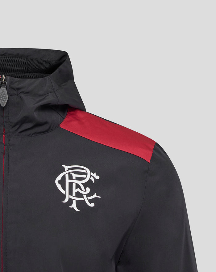 Monogram crest on chest of men's black coaches training packable hooded jacket with red shoulder panel