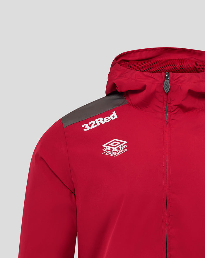 Close up of the left chest area on the red training jacket with 32Red text and a white geometric training badge