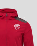 Close up of junior red hooded training jacket with front zipper and white crest logo on the chest
