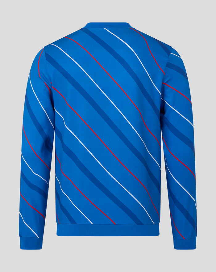 Back view of a blue unisex home matchday jacket with diagonal red and white stripes and a ribbed hem.