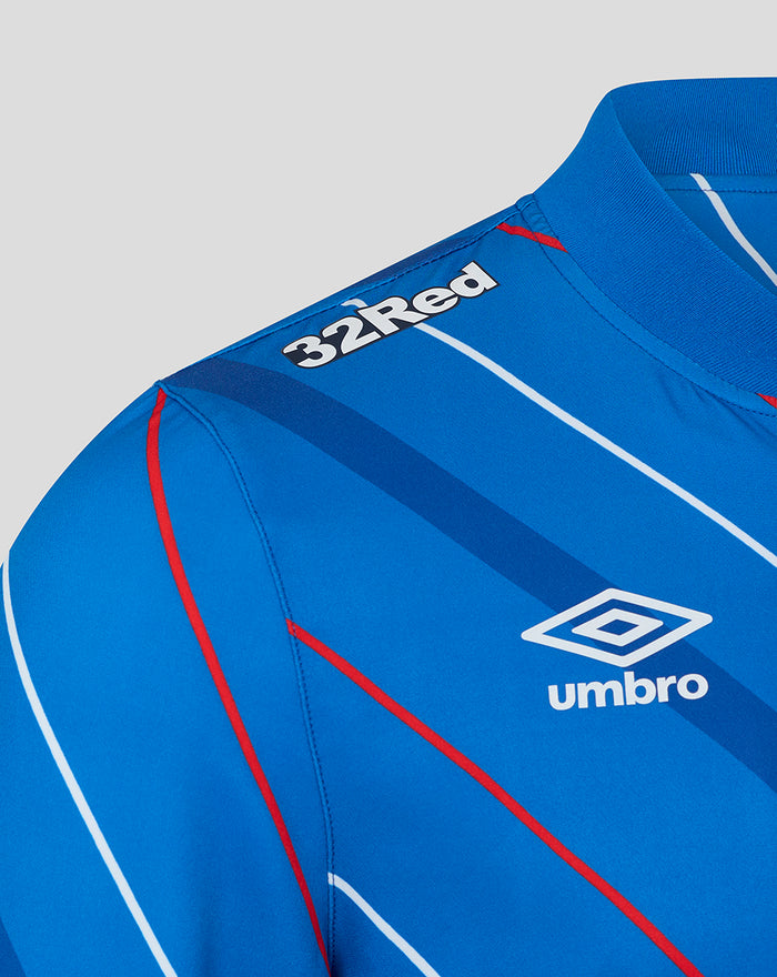 Close up of blue home jacket shoulder showing 32Red branding and Umbro logo with diagonal stripes.