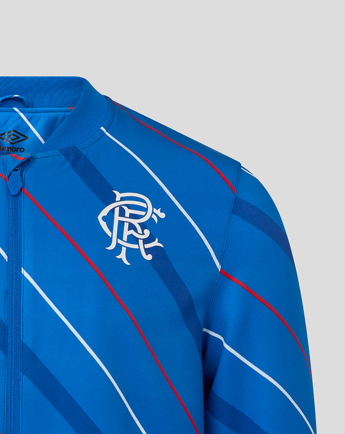 Blue home matchday jacket close up showing club crest and Umbro logo on the chest with diagonal stripes.