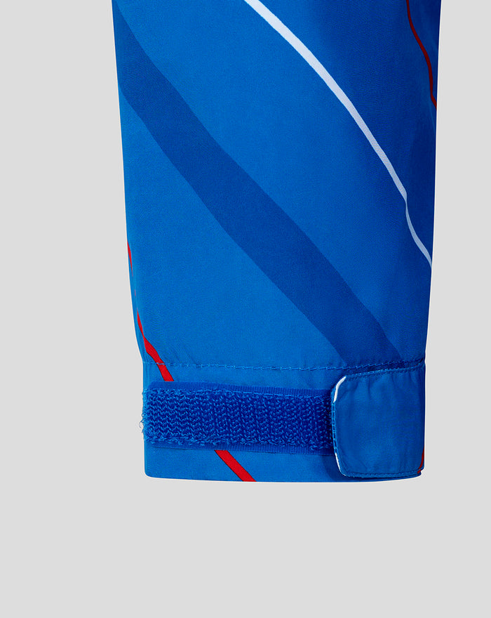 Close up of the sleeve cuff on a blue matchday shower jacket with a Velcro strap and diagonal stripes