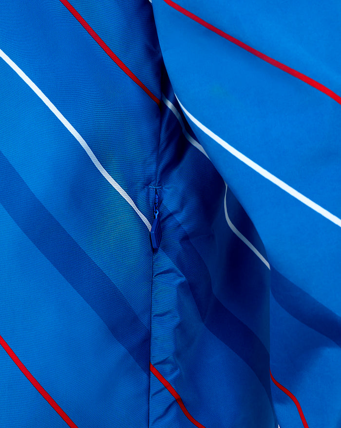 Detail of zipper and seam on blue matchday packable shower jacket showing fabric texture