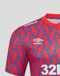 Front view of a unisex away matchday tee with red and blue geometric print, 32Red sponsor, Umbro logo and club crest.
