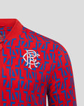 Close-up of the white club crest on the red and blue away matchday jacket