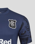 Front view of navy blue matchday T shirt with club crest on left chest and camo patterned sleeves