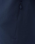 Close up of navy fabric on the Third Matchday jacket highlighting a vertical zip pocket and zipper pull
