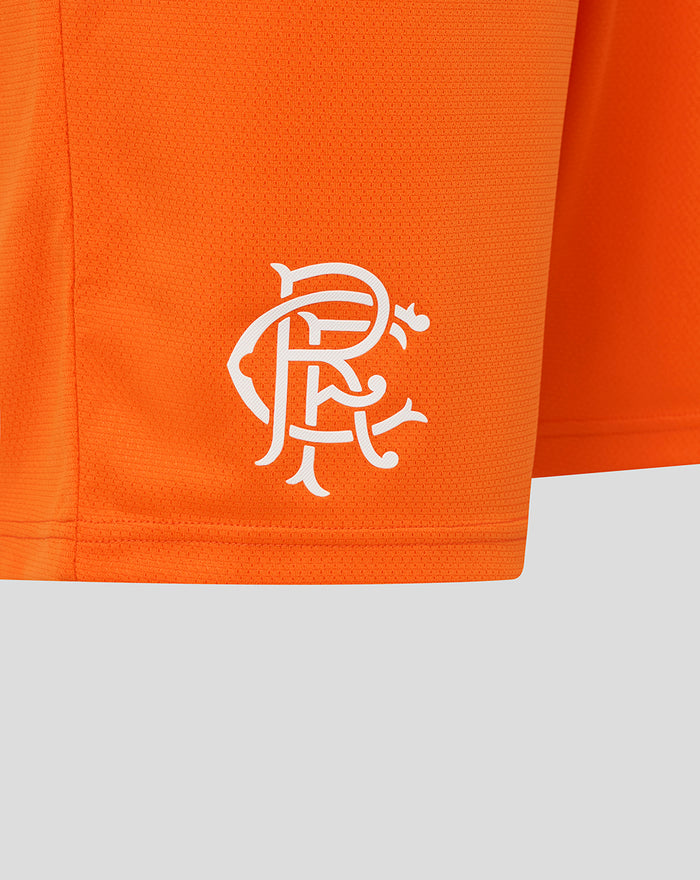 Close-up of white Rangers crest on the lower left leg of bright orange shorts.