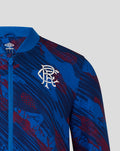 Close-up of the jacket chest showing Rangers crest and Umbro diamond on blue patterned fabric.
