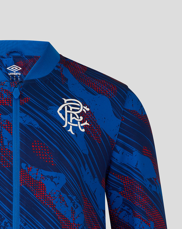 Close-up of the jacket chest showing Rangers crest and Umbro diamond on blue patterned fabric.