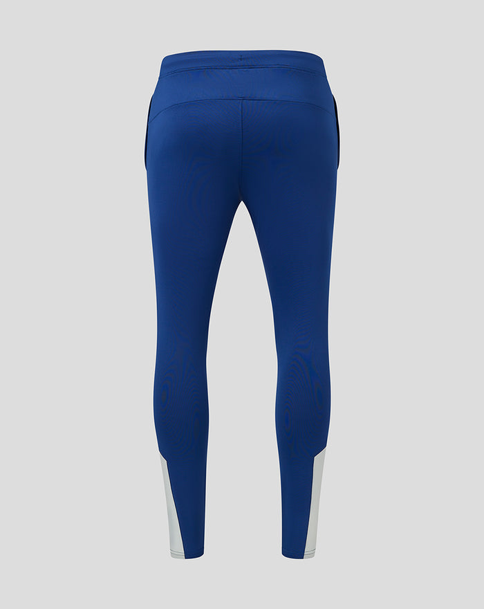 Back view of blue matchday training pants with light grey cuff panels and a curved back yoke