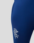 Close-up of blue Matchday training pant leg with white club crest at the hem