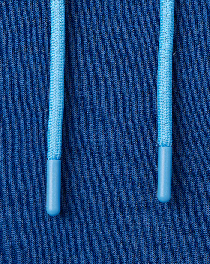 Close-up of light blue drawstrings with plastic tips on navy hoodie fabric