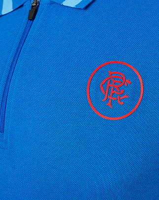 Close up of blue polo fabric with red Rangers crest on the chest