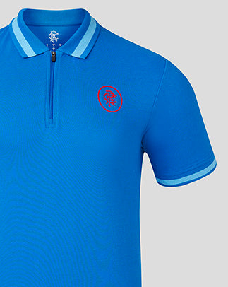Angled view of blue Rangers polo with zip collar and left chest crest