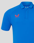 Blue polo shirt close-up highlighting the club crest on the chest with Castore branding nearby.