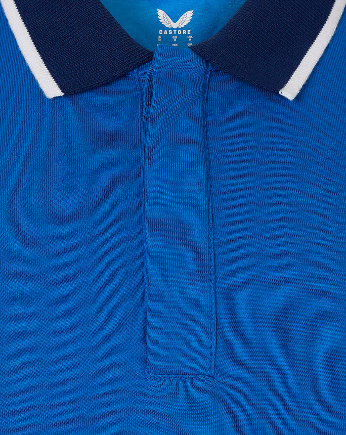Close-up of blue Iconic Ibrox Polo collar showing navy rib with white tipping and Castore label at neck
