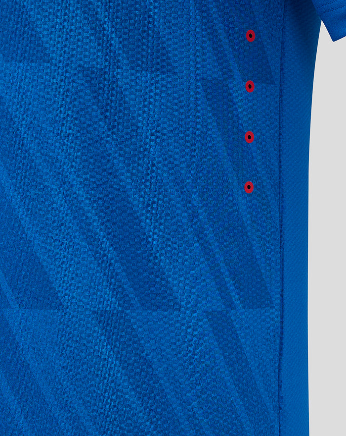 Close up of blue Rangers Pro Home Long Sleeve shirt fabric showing mesh texture and red eyelets along the side seam.