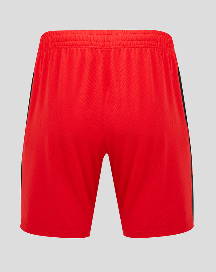Back view of red athletic shorts with a black side stripe.