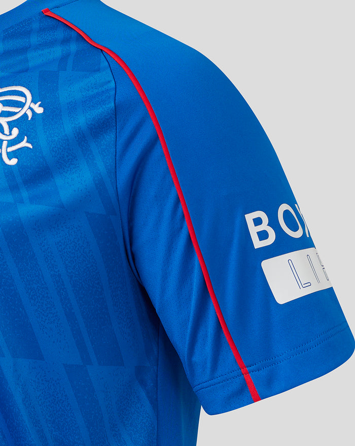 Detail of the Rangers home shirt sleeve with red piping and textured pattern on blue fabric