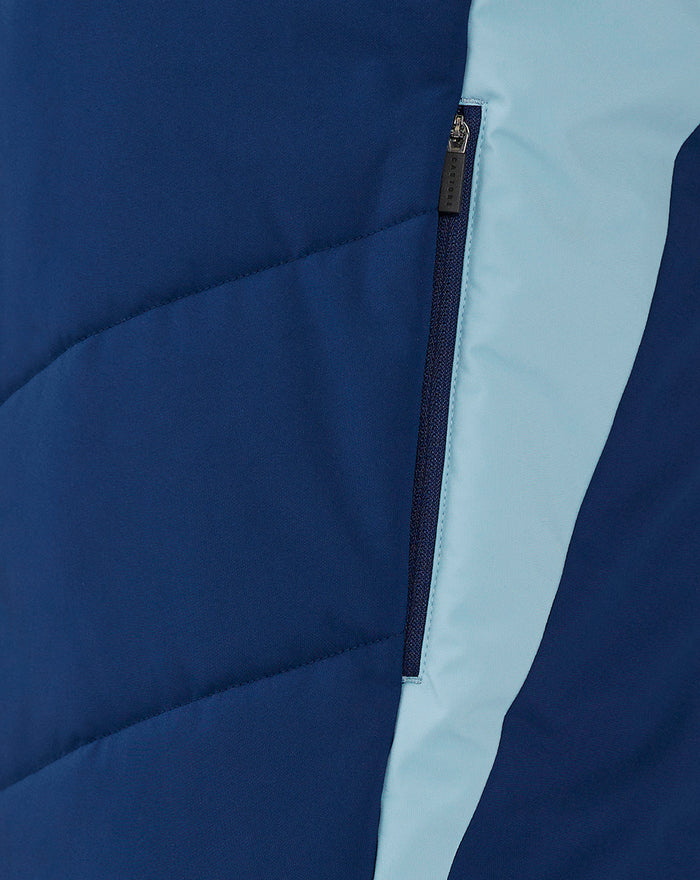 Close up of navy blue jacket zipper with light blue side panel.