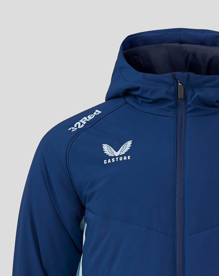 Close-up of blue hooded jacket showing crest logo on chest and zipper
