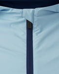 Close-up of light blue fabric with navy zipper on a Rangers training jacket