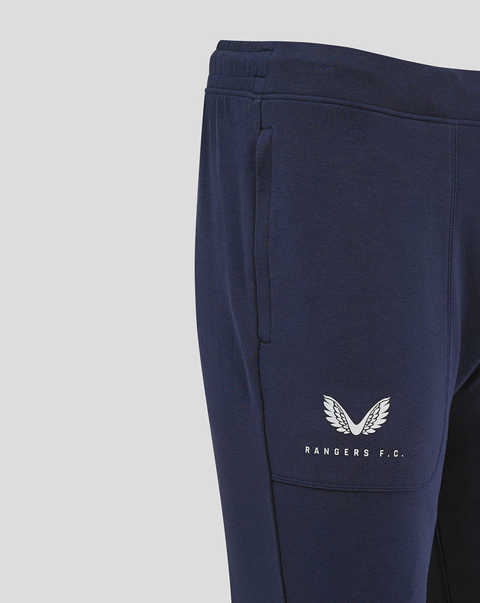 Front view of navy Rangers FC travel pants featuring a winged crest logo on the left thigh.