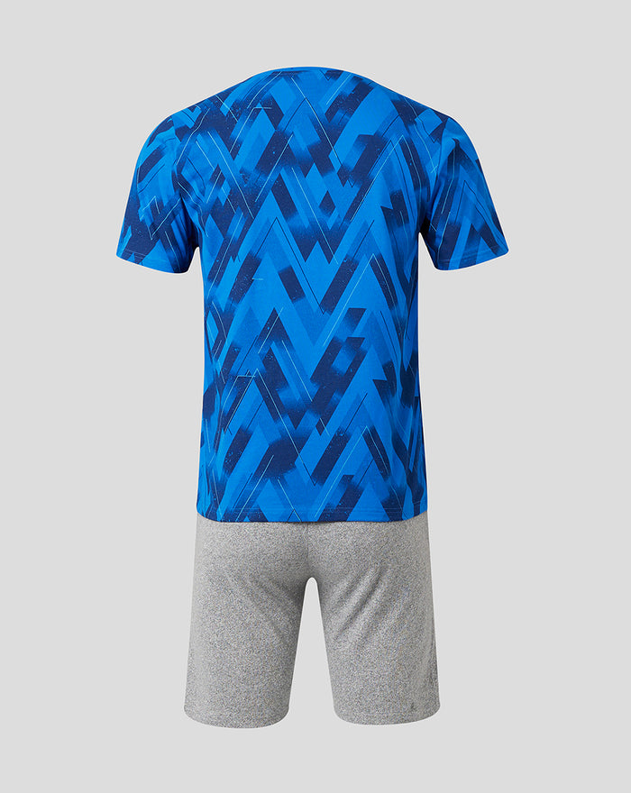 Back view of blue geometric print short sleeve pajama top with gray shorts.