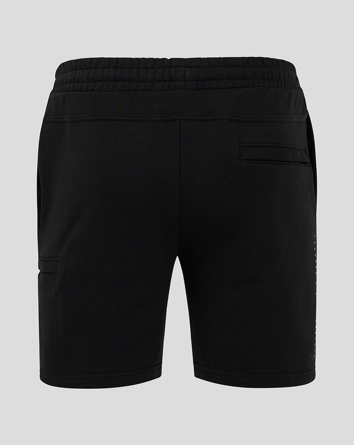 Rear view of black men's 24/25 shorts with elastic waistband and a single back welt pocket