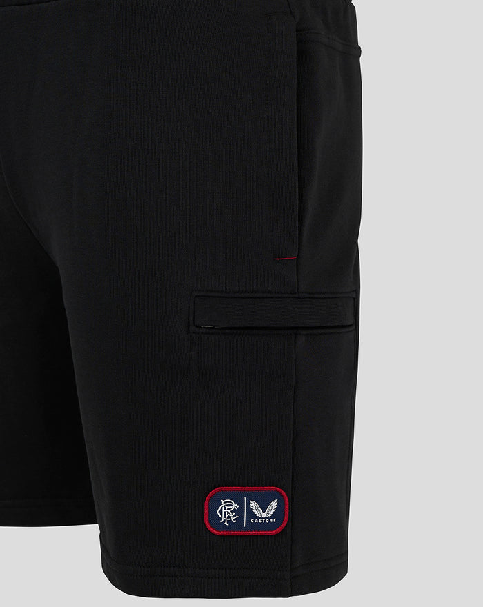 Close up of black men's 24/25 shorts showing a red bordered patch with Rangers FC and Castore branding near the hem