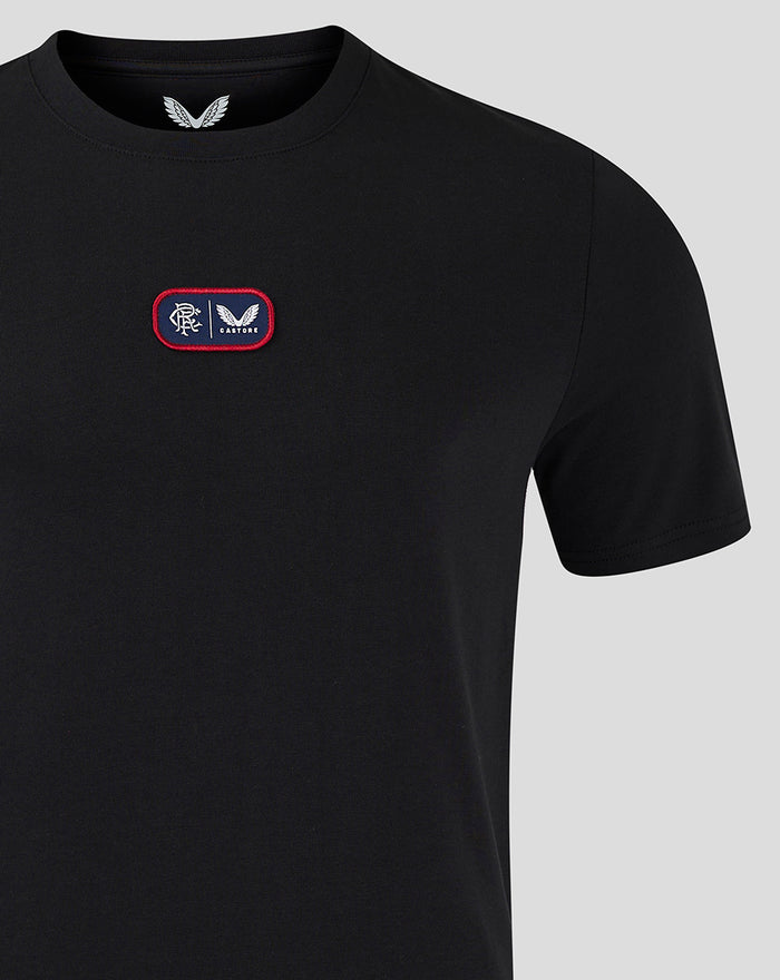 Close up of black T shirt displaying a red bordered chest patch logo.