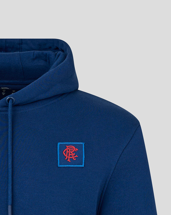 Close-up of the blue Rangers Charity Foundation hoodie showing the chest crest patch and hood detail