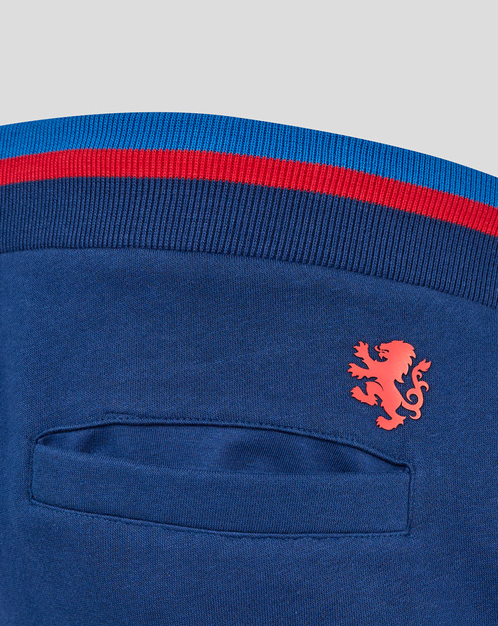 Navy Rangers joggers close-up showing ribbed waistband with blue and red stripe back pocket and red crest badge on thigh