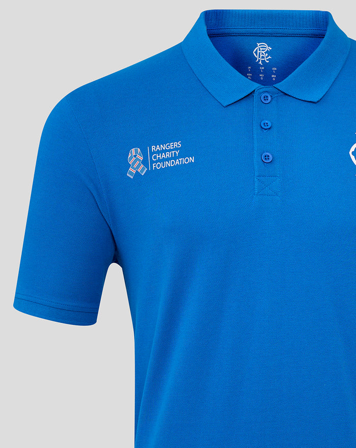 Close-up of royal blue Rangers Charity Foundation core polo showing left chest logo and three button placket