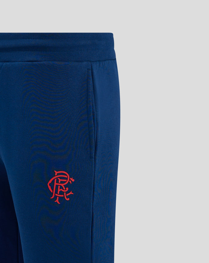 Close up of navy Rangers FC joggers showing ribbed waistband and red club crest on left thigh