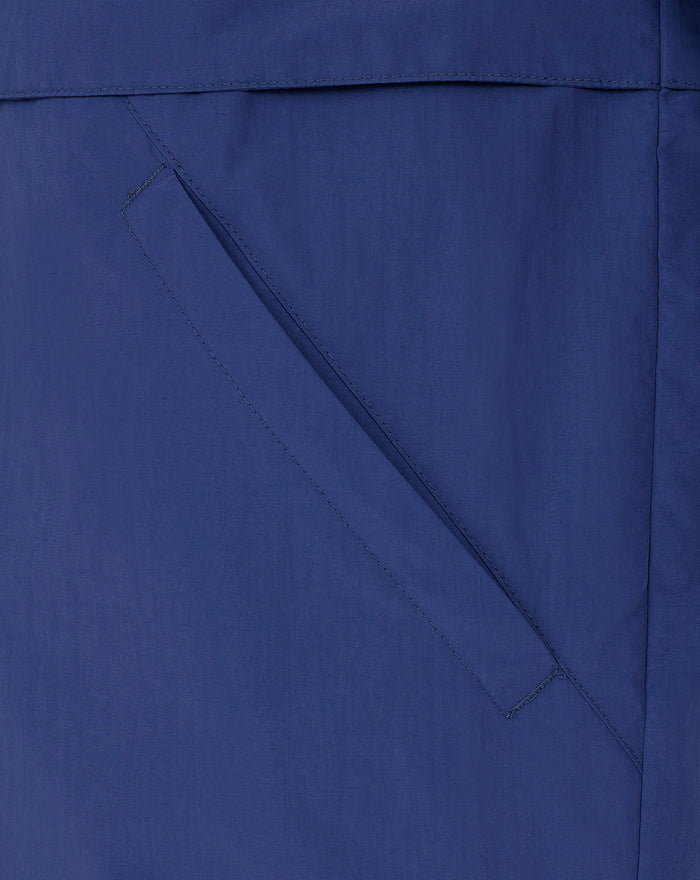 Blue men's anorak sleeve with a red bordered patch featuring white crest and Castore logos.