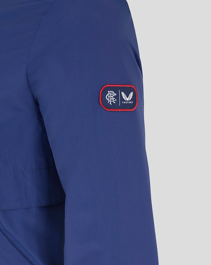 Close-up of blue sleeve patch with red border and white logos from Castore.