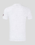 Back view of white lifestyle T shirt with all over geometric print and a sleeve patch.