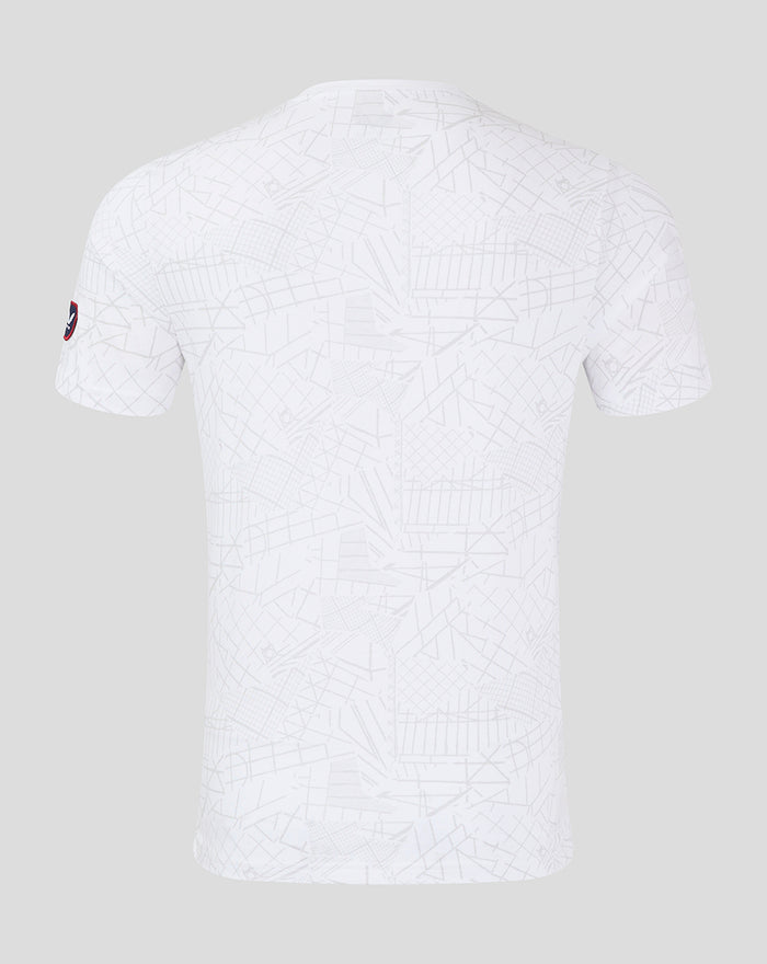 Back view of white lifestyle T shirt with all over geometric print and a sleeve patch.